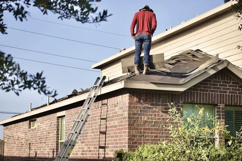 Professional roofer working on a residential roof in Kensington Farms